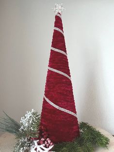 a small red christmas tree sitting on top of a table