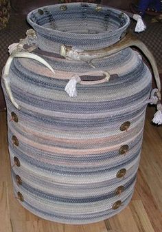 a large round crocheted basket sitting on top of a hard wood floor