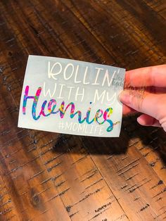 a person holding up a sticker that says kollin with my hennies