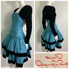 "Beautiful 1980s Miss O by Oscar de la Renta dress. Gorgeous blue taffeta with tule layered under each tier, black velvet sleeves and trim on skirt. This label is a step down from couture, and is constructed beautifully. Center back zipper closure, gathered bodice, this dress is quite heavy and full. There are a few faint small water marks on the skirt that are not very noticeable but mentionable. as this item has not yet been cleaned and  we have priced it accordingly. It's an absolutely stunning dress and really shows it quality and design Bust: 32\" Waist: 26\" Hip: 32-34\" Sleeve: 23.25\" Length: 39.25\" If you have any questions or would like more information about this listing, please don't hesitate to ask." 80s Fashion Formal Classy, Layerd Dress, 1980's Dresses, Dynamic Clothes, Perfect Blue Dress, 2000 Dresses, Skirt As A Dress, Short Dress Outfit, Blue Dress With Sleeves