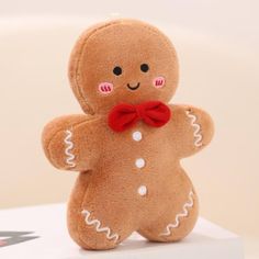 a small stuffed ginger with a red bow tie on it's head and arms