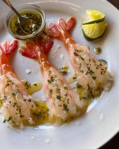 a white plate topped with shrimp and sauce