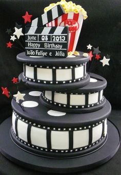 a birthday cake made to look like a film strip with popcorn and stars on top