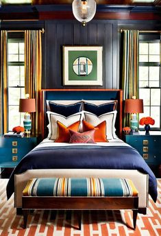 a bedroom with blue walls and orange curtains