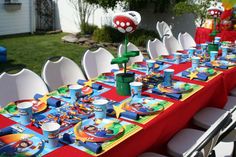 a table set up with mario birthday decorations