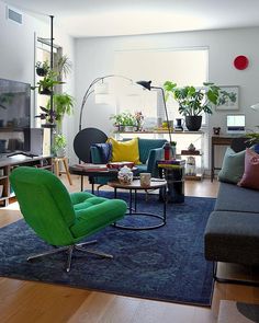 a living room filled with furniture and lots of plants