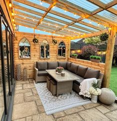 an outdoor living area with patio furniture and string lights