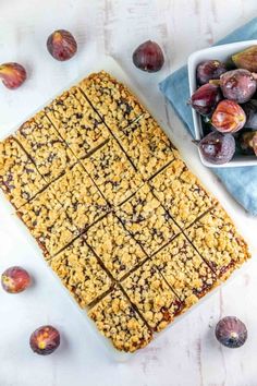 an image of plums and oatmeal bars on a table