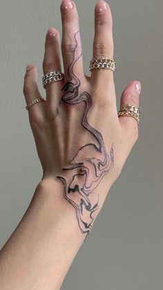 a woman's hand with tattoos on it