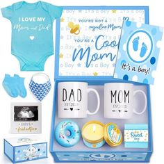 a baby shower gift set includes two mugs, a bodysuit and a pacifier