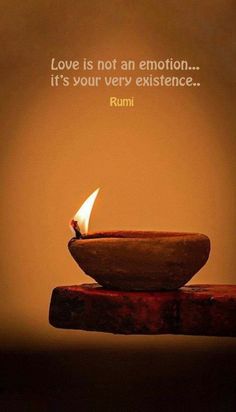 a small lit candle sitting on top of a wooden table next to a brown wall