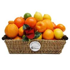 a basket filled with lots of oranges and lemons