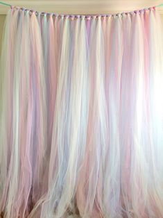 there is a pink and white curtain hanging on the wall