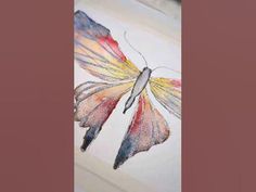 a watercolor painting of a colorful butterfly