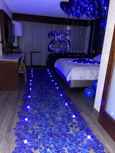 a bed room with blue decorations and balloons