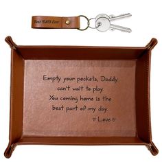 a leather tray with a keychain attached to it that says empty your packets, daddy can't wait to play you coming home is the best part of my day