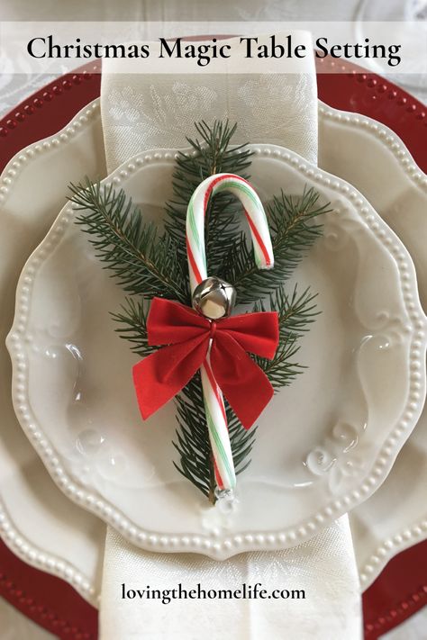 Christmas tablescape with red chargers and a candy cane garnished with a pine sprig, red bow, and bell. Magic Table, Christmas Table Setting, White Plate, Candy Canes, Christmas Magic, Christmas Table, Pie Dish, Table Setting, Christmas Decoration