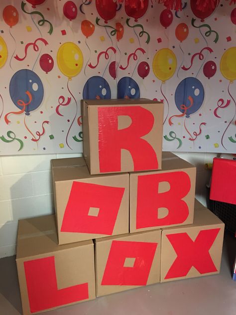 Moving boxes and paper letters glued on Roblox Box Ideas, Roblox Birthday Party Ideas Printables, Birthday Roblox Party Ideas, Roblox Birthday Party Ideas Decor, Diy Roblox Party Decorations, Roblox Party Ideas For Boys, Roblox Decoration Ideas, Roblox Birthday Decorations, Roblox Birthday Party Ideas For Boys