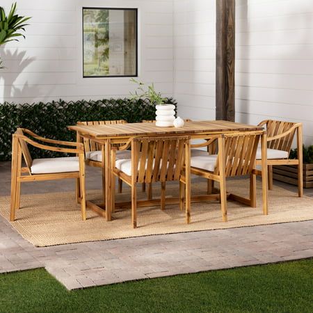 Make room for a crowd with the Walker Edison Modern 7-Piece Slatted Outdoor Dining Set. This set includes one dining table and six chairs, so you can dine in style all summer long. The slatted tabletop and seat backs inspire memories of picnics in the park, while the tables geometric legs ground the set in stylish modernity. Gather your closest friends and family around the spacious tabletop for dinner and drinks on warm summer evenings. The comfortable cushioned seats invite guests to relax and enjoy good food and great conversation. Built from naturally weather-resistant acacia wood, this modern set can be maintained with teak oil as needed to keep your furniture in tip-top shape for years to come. Color: Brown. Covered Patio Table And Chairs, Backyard With Picnic Table, Mexican Outdoor Table, Teak Patio Dining Table, Deck Table And Chairs, Patio Dining Ideas Outdoor, Boho Outdoor Dining, Plants Front Porch, Creek Backyard