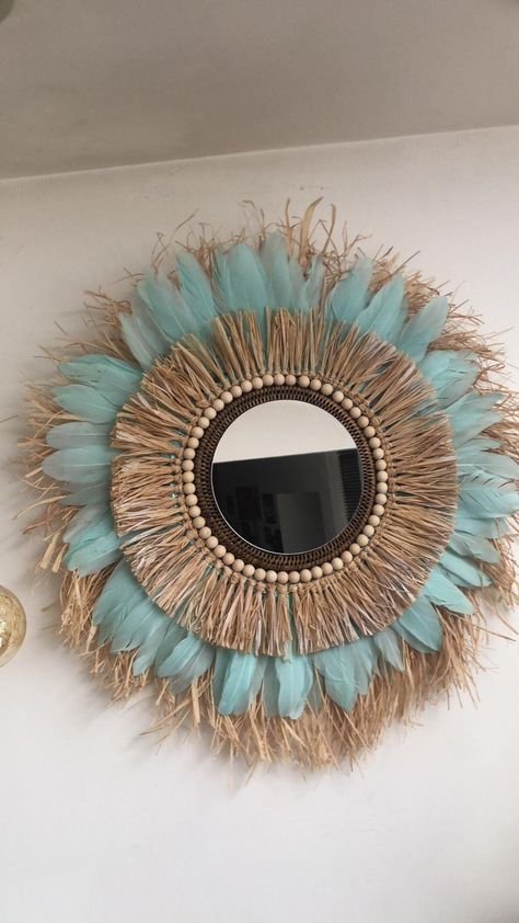 "Bohemian color   Add a unique and artisanal touch to your interior decoration with our decorative mirror in turquoise feather and double raffia crown. Handcrafted with natural materials, this mirror brings an elegant and fresh touch to any room in your home. Wooden beads add an extra touch of charm to this handmade mirror. Use it to beautify your bedroom, living room or any room in your home with a natural and eco-friendly interior. Order our decorative feather and raffia mirror now for a uniq Decorating With Wooden Beads, Feather Mirror, Raffia Mirror, Eco Friendly Interior, Boho Mirror, Mirror Handmade, Wall Art Diy Paint, Bohemian Decoration, Boho Crafts Diy