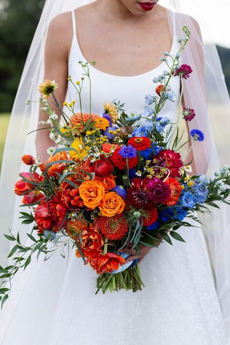 Red Yellow Blue Wedding Flowers, Popular Flower Arrangements, Trader Joe Wedding Bouquet, Blue Red Orange Wedding Flowers, Wedding Bouquet Bright Colors, Wildflower Whimsical Wedding, Red Orange And Blue Wedding, Colorful Flowers Wedding Decoration, Red Orange Flowers Wedding