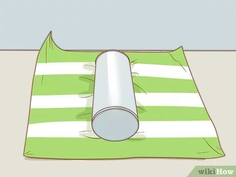 3 Ways to Wrap a Round Gift - wikiHow How To Wrap Tubular Gifts, How To Gift Wrap A Cylinder, How To Gift Wrap Cylinders, Gift Wrapping A Rolled Blanket, Round Wrapping Ideas, How To Gift Wrap A Rolled Up Blanket, Wrapping Round Tins, Wrapping Tube Shaped Gifts, Wrapping A Round Tin