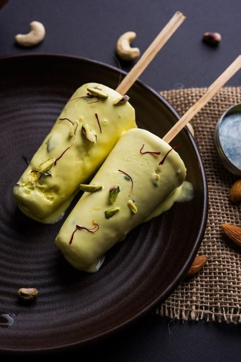 Two Indian kulfi ice creams with pistachio, almond, and cashew on sticks. Indian Pudding Recipe, Semiya Payasam, Indian Ice Cream, Indian Pudding, Kulfi Recipe, Indian Dessert, Healthy Food Dishes, Yummy Ice Cream, Tastemade Recipes