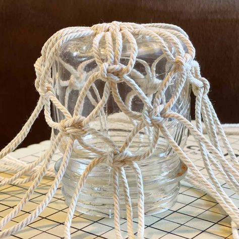 DIY Macrame Glass Jar Covers Made with Square Knots Macrame Glass Jar, Macrame Mason Jar, Mason Jar Hanger, Diy Macrame Projects, Macrame Candle Holder, Jar Covers, Macrame Plant Hanger Patterns, Simple Macrame, Diy Macrame Plant Hanger