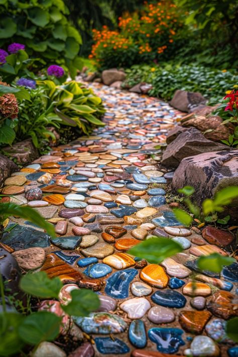 boho garden pathway by colorful stones Diy Mosaic Garden Path, Pebble Sidewalk Ideas, Rock Flower Path, Creative Garden Paths Walkway Ideas, Rustic Deck Decorating Ideas, Creative Rock Garden Ideas, Brick Back Patio, Boho Pathway, Beautiful Patio Ideas