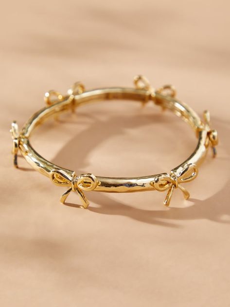 This delicate gold bow bracelet adds a touch of girly to your wrist. The gold bows stand out and the stretchy band ensures a comfortable fit for all-day wear. Dress it up or down, this bracelet is a versatile addition to any jewelry collection. Pandas, Evry Jewels Bracelet Stack, Yellow Gold Bracelet Stack, Nice Gold Jewelry, Tiffany And Co Gold Jewelry, Elegant Jewelry Classy Gold, Wrist Jewelry Aesthetic, Cute Jewelry Gold, Pretty Gold Jewelry