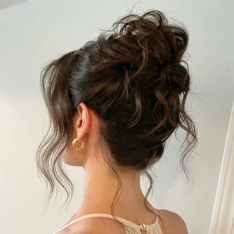 Messy wavy bun wedding hairstyle Low Curled Bun Wedding Hair, Cute Fancy Updos, High Hairstyles Bun, Loose Bun Prom Hair, Formal Messy Bun High, Curled French Twist, Hair For Mock Neck Dress, Aesthetic Hairstyles For Party, Brunette Bridesmaid Hairstyles Updo