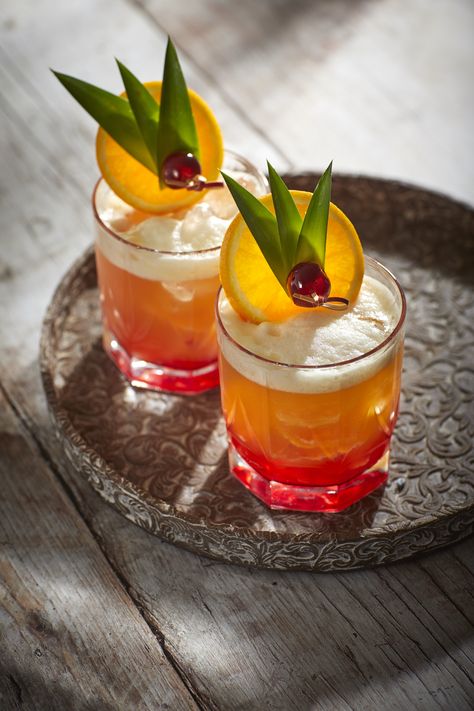 Rum Punch Reinvented - This recipe for rum punch uses iconic flavours from the Caribbean island. Garnish with an orange wheel, 3 pineapple leaves, and a glacé cherry on a cocktail stick. Tiki Drink Garnish, Tiki Cocktail Garnish, Orange Garnish Cocktail, Cocktail Garnishes Unique, Cocktail Garnish Ideas Creative, Margarita Garnish, Pineapple Garnish, Cocktail Garnish Ideas, Garnish Drink