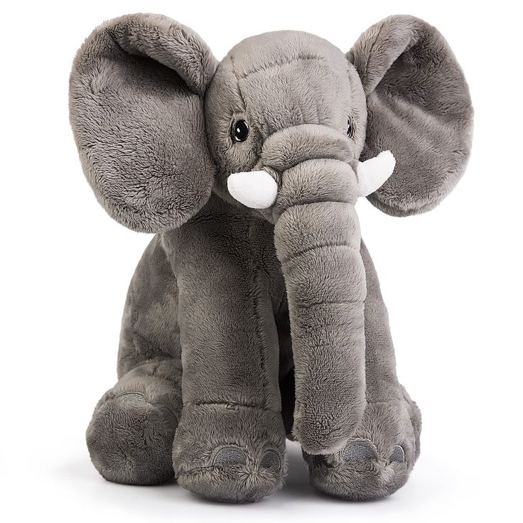 an elephant stuffed animal sitting up against a white background