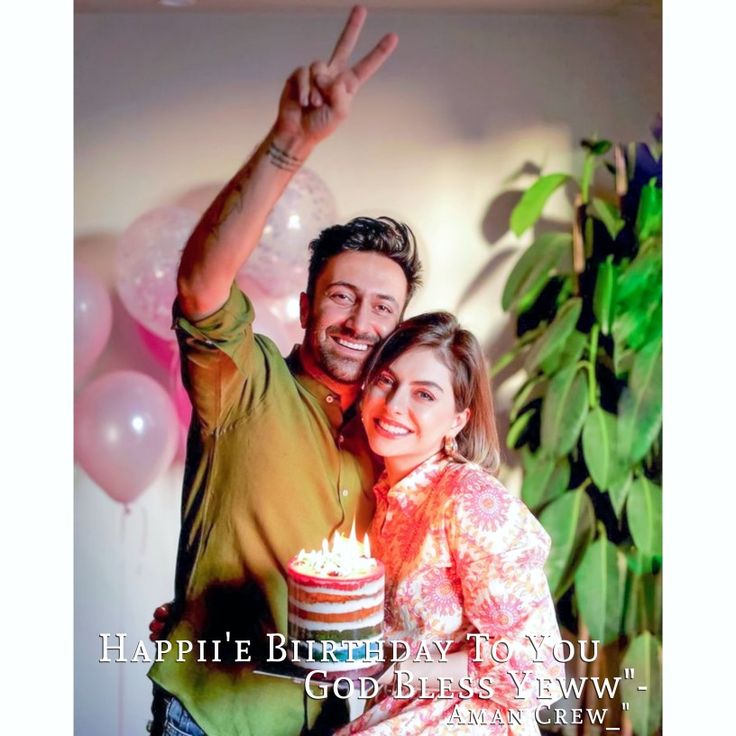 a man and woman are holding a cake