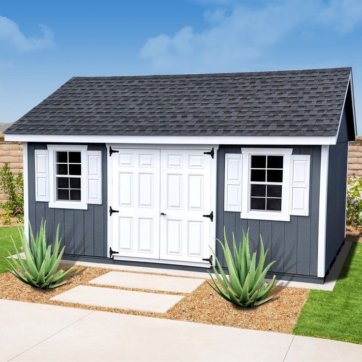 a small shed with two plants in front of it