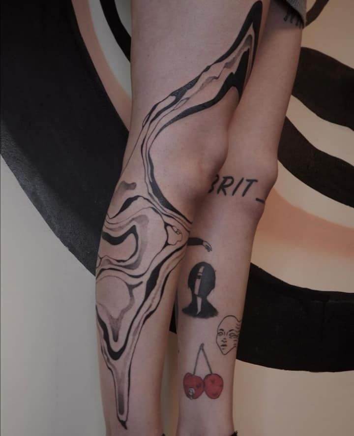 a woman's legs with tattoos on them