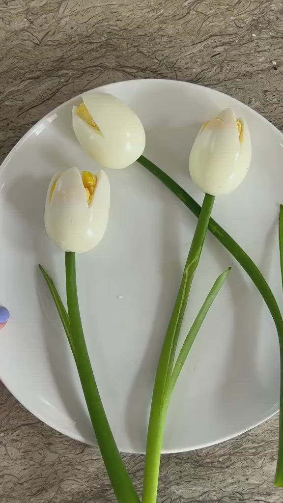 This may contain: three white flowers sitting on top of a white plate