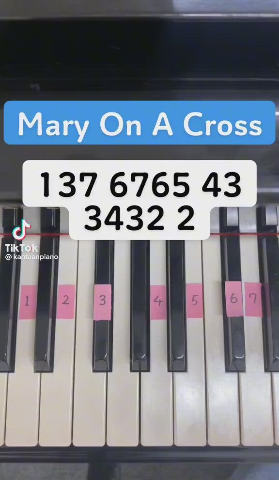 This may contain: a close up of a piano keyboard with the words mary on a cross