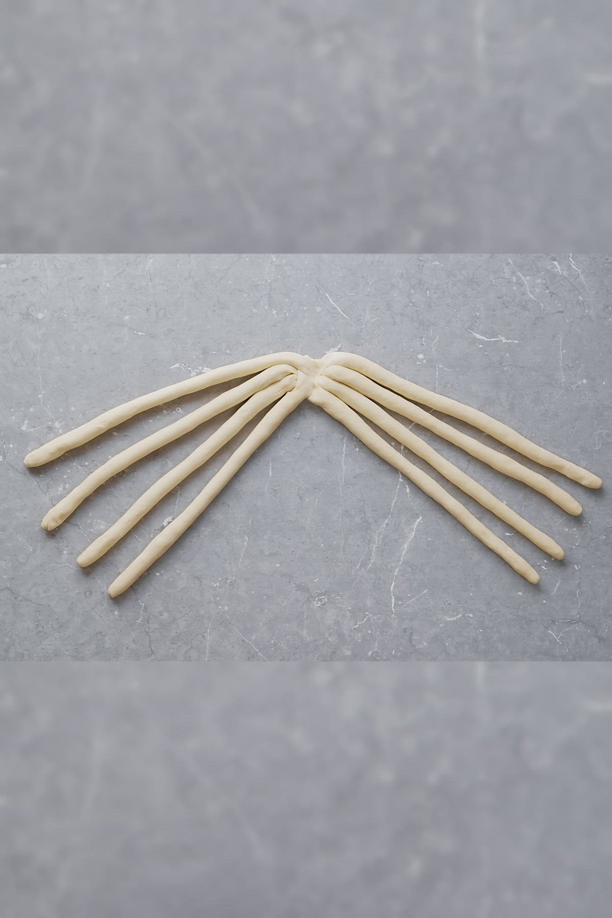 This may contain: several toothpicks are arranged on a gray surface with white lines in the middle