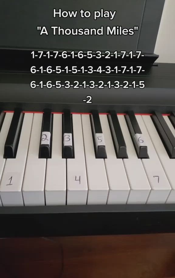 This may contain: a piano with the words how to play'a thousand miles'on it