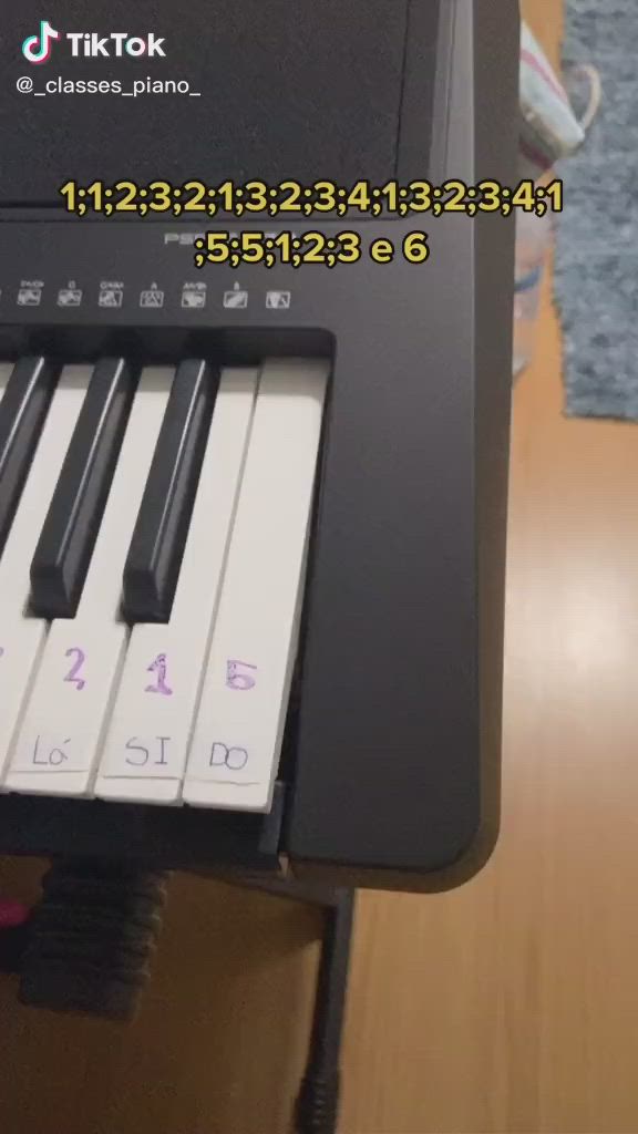 This may contain: an electronic piano sitting on top of a wooden table