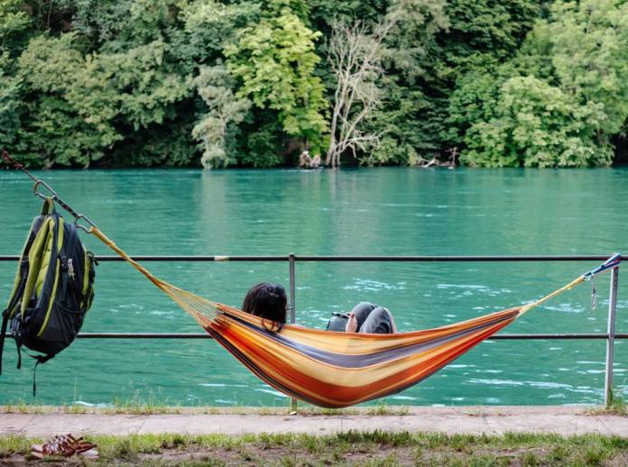 Publisher lying in hammock reading an ebook