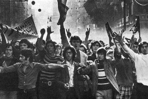 Black and White people of a large crowd of university students (primarily males) demonstrating in the streets.