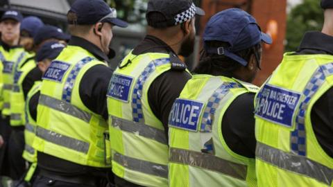 A row of Greater Manchester Police officers line up during the unrest which followed the 29 July Southport stabbings