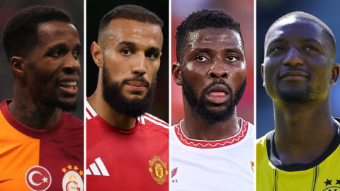 A composite image in four vertical slices featuring, from left to right, Wilfried Zaha in Galatasaray colours, Noussair Mazraoui playing for Manchester United, Kelechi Iheanacho in white Sevilla shirt, Serhou Guirassy in Borussia Dortmund yellow and black