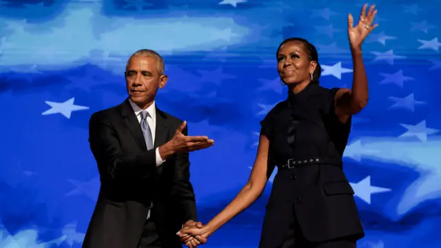 Ex-US president Barack Obama with former first lady Michelle Obama on the convention stage.