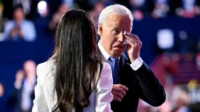 US President Joe Biden wipes away tears, with daughter Ashley Biden near him, on the first night of the DNC.