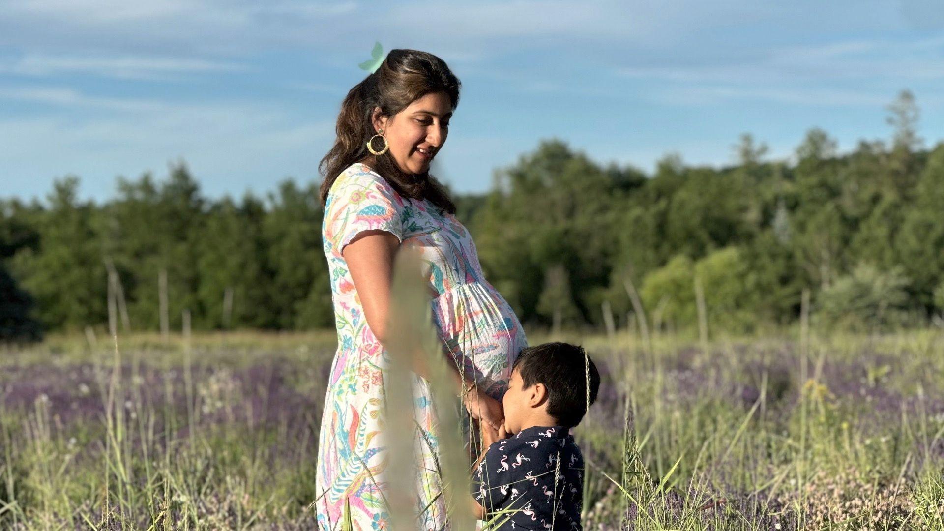 A pregnant woman with her young son in a lavender field