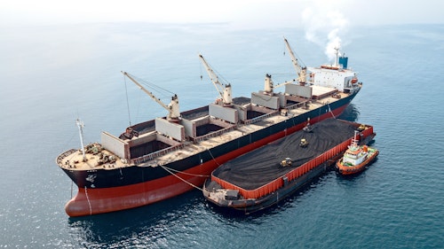 Photo depicts Loading Unloading Coal From Barge to Mother Vessel