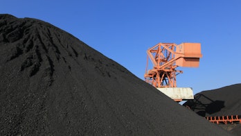 Cover of Driving Down Coal Mine Methane Emissions - Photo showing coal mine and red digger next to stockpiles